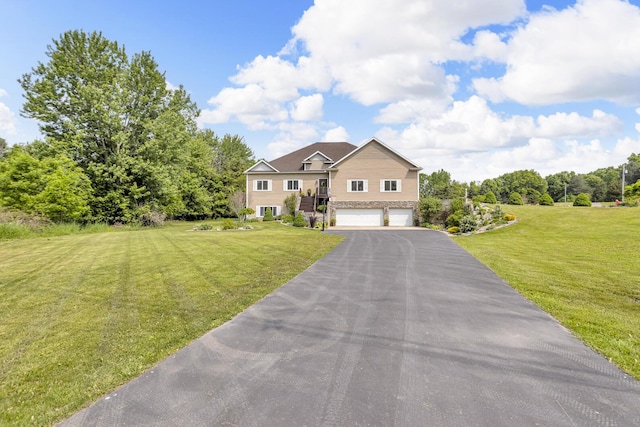 7910 Stony Lake Rd, Jackson, MI 49201 - view of front of property with an attached garage, a front lawn, stone siding, and driveway