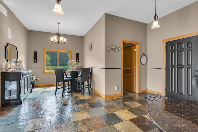 7910 Stony Lake Rd, Jackson, MI 49201 - dining space featuring stone tile flooring, baseboards, and a chandelier