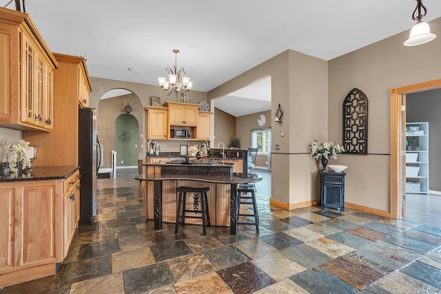 7910 Stony Lake Rd, Jackson, MI 49201 - kitchen featuring freestanding refrigerator, stone tile flooring, black microwave, baseboards, and arched walkways