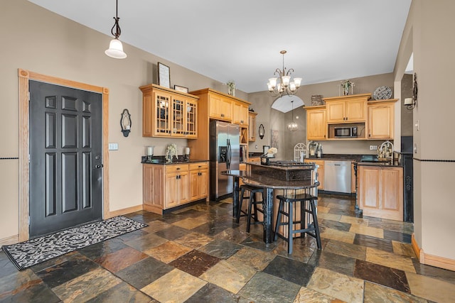 7910 Stony Lake Rd, Jackson, MI 49201 - kitchen with stainless steel appliances, baseboards, dark countertops, and stone tile floors
