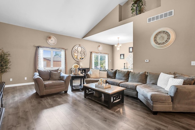 7910 Stony Lake Rd, Jackson, MI 49201 - living room with dark wood-style flooring, high vaulted ceiling, and baseboards