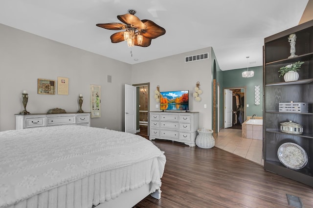 7910 Stony Lake Rd, Jackson, MI 49201 - bedroom with a walk in closet, dark wood-style flooring, a closet, and ceiling fan