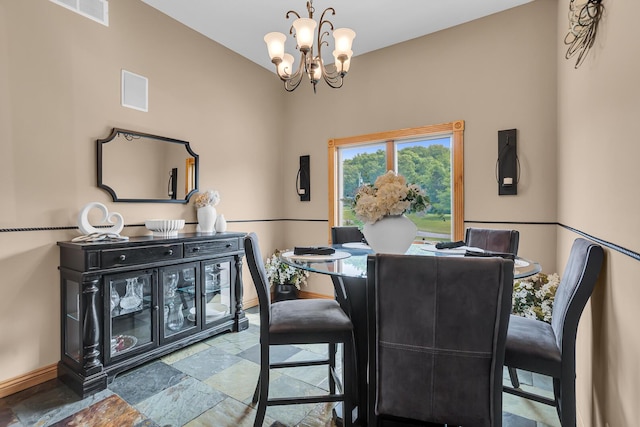 7910 Stony Lake Rd, Jackson, MI 49201 - dining room with stone tile floors, baseboards, and a chandelier