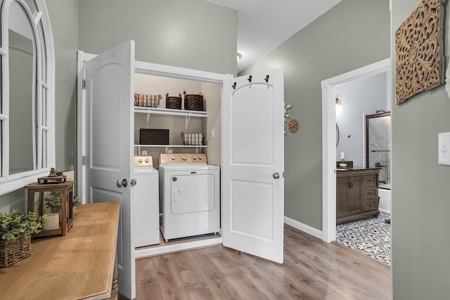 7910 Stony Lake Rd, Jackson, MI 49201 - laundry area with washer and dryer, light wood finished floors, and baseboards