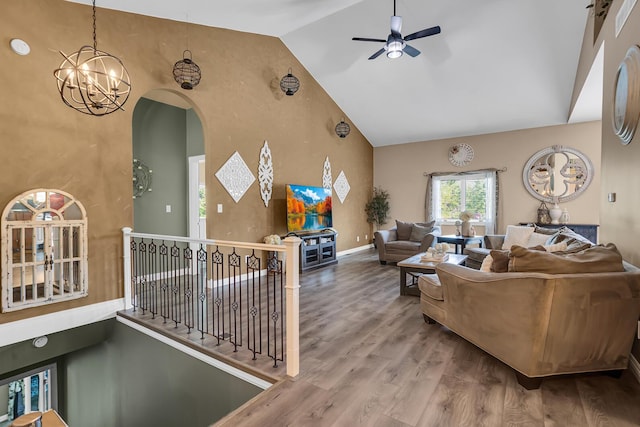 7910 Stony Lake Rd, Jackson, MI 49201 - living room featuring high vaulted ceiling, wood finished floors, ceiling fan, a chandelier, and arched walkways