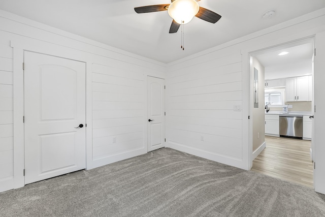 3551 W W Lake Mitchell Dr, Cadillac, MI 49601 - unfurnished bedroom with light carpet and a ceiling fan