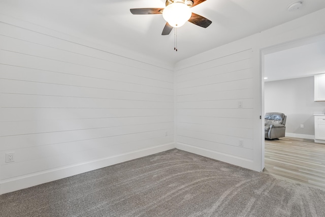 3551 W W Lake Mitchell Dr, Cadillac, MI 49601 - empty room with a smoke detector, a ceiling fan, baseboards, and light carpet