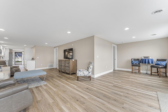 3551 W W Lake Mitchell Dr, Cadillac, MI 49601 - living room with baseboards, light wood-style floors, and recessed lighting