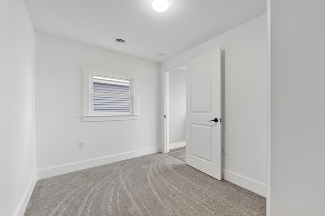 3551 W W Lake Mitchell Dr, Cadillac, MI 49601 - empty room with carpet flooring and baseboards