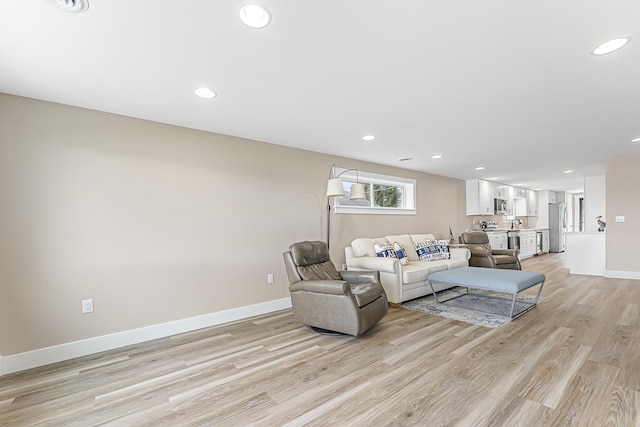 3551 W W Lake Mitchell Dr, Cadillac, MI 49601 - living area with light wood finished floors, recessed lighting, and baseboards