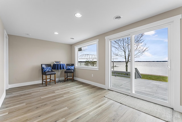 3551 W W Lake Mitchell Dr, Cadillac, MI 49601 - office featuring light wood-style flooring, baseboards, a water view, and recessed lighting