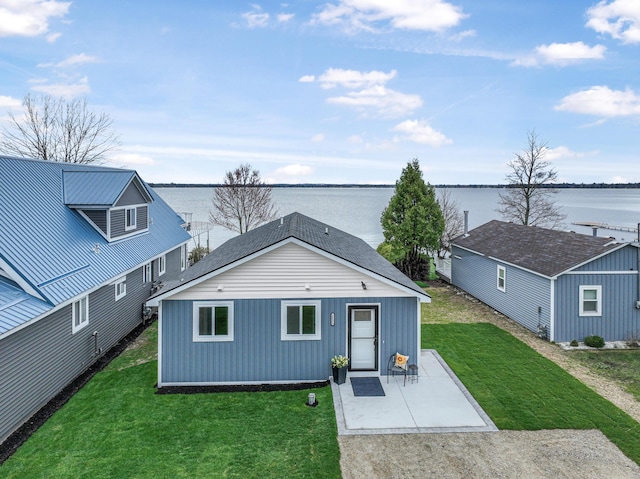 3551 W W Lake Mitchell Dr, Cadillac, MI 49601 - view of front facade featuring a patio, a water view, and a front yard