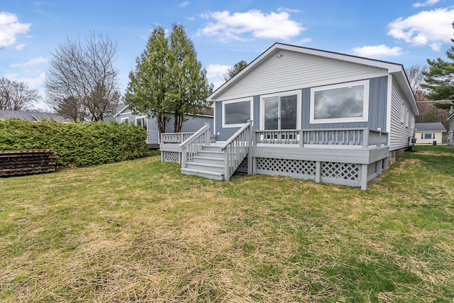 3551 W W Lake Mitchell Dr, Cadillac, MI 49601 - rear view of house featuring a deck and a lawn