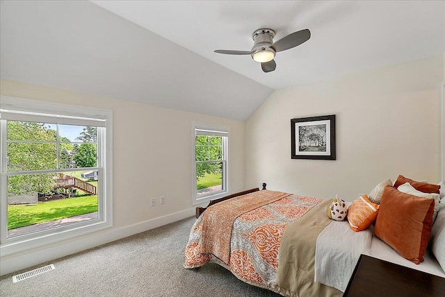 2582 3 Mile Rd NE, Grand Rapids, MI 49525 - carpeted bedroom with multiple windows, lofted ceiling, baseboards, and a ceiling fan