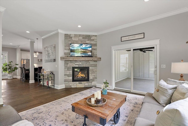 2582 3 Mile Rd NE, Grand Rapids, MI 49525 - living room with dark wood-type flooring, ornamental molding, a stone fireplace, baseboards, and recessed lighting