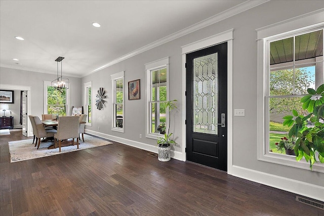 2582 3 Mile Rd NE, Grand Rapids, MI 49525 - dining space with baseboards, a chandelier, dark wood finished floors, recessed lighting, and crown molding
