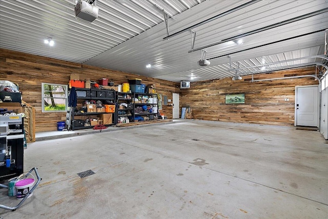2582 3 Mile Rd NE, Grand Rapids, MI 49525 - garage featuring wood walls and a garage door opener
