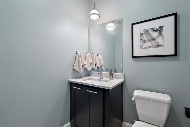 2582 3 Mile Rd NE, Grand Rapids, MI 49525 - half bathroom with toilet, vanity, and baseboards