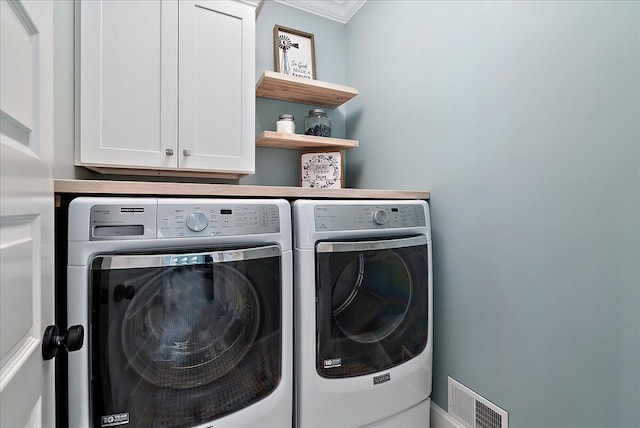 2582 3 Mile Rd NE, Grand Rapids, MI 49525 - laundry area with washer and dryer, crown molding, and cabinet space