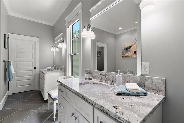 2582 3 Mile Rd NE, Grand Rapids, MI 49525 - bathroom with crown molding, two vanities, tile patterned flooring, and baseboards