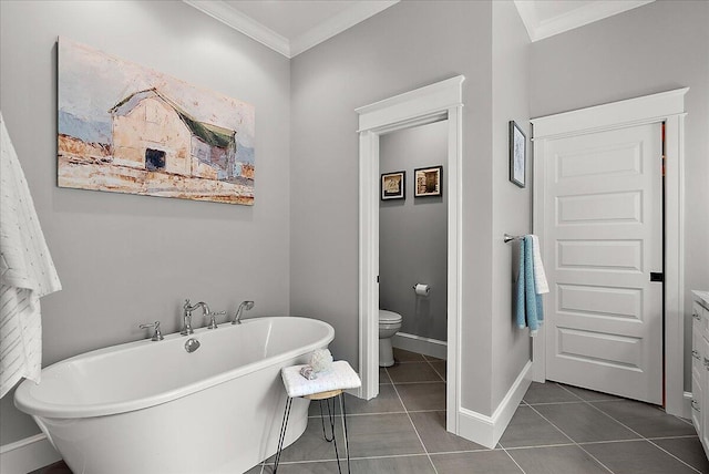2582 3 Mile Rd NE, Grand Rapids, MI 49525 - bathroom featuring crown molding, a freestanding tub, tile patterned flooring, toilet, and baseboards