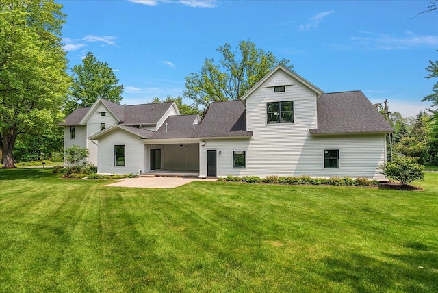2582 3 Mile Rd NE, Grand Rapids, MI 49525 - back of property featuring a patio area, a ceiling fan, a yard, and roof with shingles