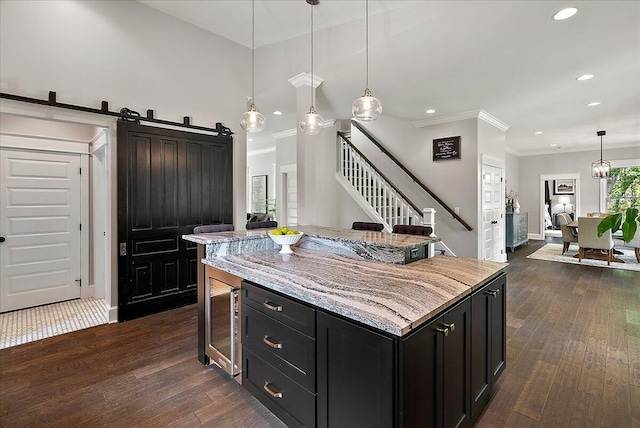 2582 3 Mile Rd NE, Grand Rapids, MI 49525 - kitchen with recessed lighting, dark cabinetry, dark wood-style floors, wine cooler, and crown molding