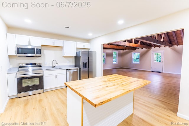 50824 Baltimore St, New Baltimore, MI 48047 - kitchen featuring appliances with stainless steel finishes, a sink, white cabinetry, light wood-type flooring, and open floor plan