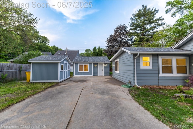 50824 Baltimore St, New Baltimore, MI 48047 - ranch-style house featuring roof with shingles, driveway, and an outdoor structure