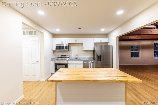 50824 Baltimore St, New Baltimore, MI 48047 - kitchen featuring stainless steel appliances, a sink, white cabinetry, light wood finished floors, and recessed lighting