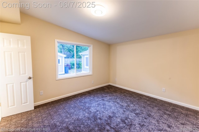 50824 Baltimore St, New Baltimore, MI 48047 - spare room with dark carpet, baseboards, and vaulted ceiling