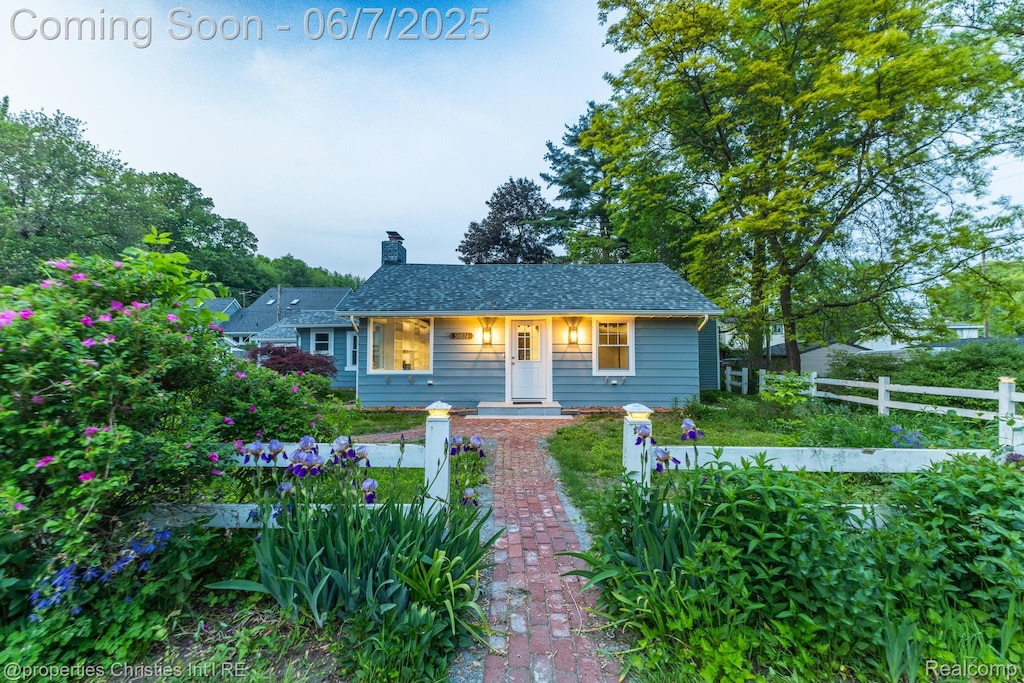 50824 Baltimore St, New Baltimore, MI 48047 - bungalow-style home with a chimney and roof with shingles