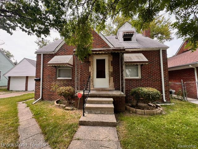 20951 Nummer St, Warren, MI 48089 - bungalow with brick siding, a chimney, and a garage