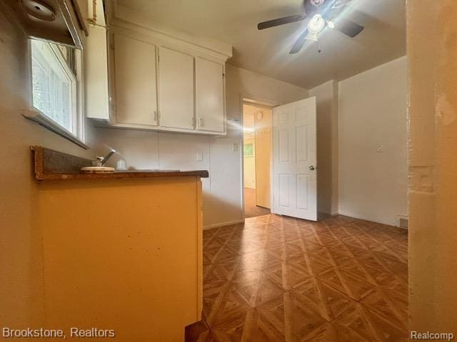 20951 Nummer St, Warren, MI 48089 - kitchen featuring a ceiling fan, white cabinetry, and dark countertops