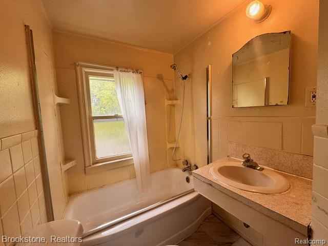 20951 Nummer St, Warren, MI 48089 - full bathroom with tub / shower combination, tile walls, and vanity