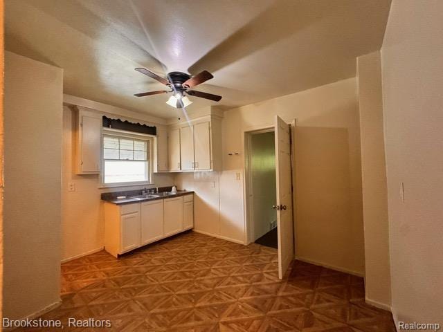 20951 Nummer St, Warren, MI 48089 - kitchen with ceiling fan, white cabinetry, and dark countertops