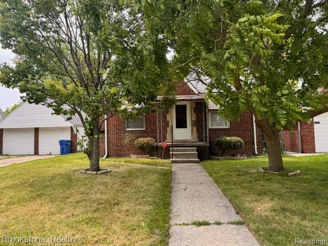 20951 Nummer St, Warren, MI 48089 - view of property hidden behind natural elements with brick siding, a front lawn, entry steps, and a detached garage
