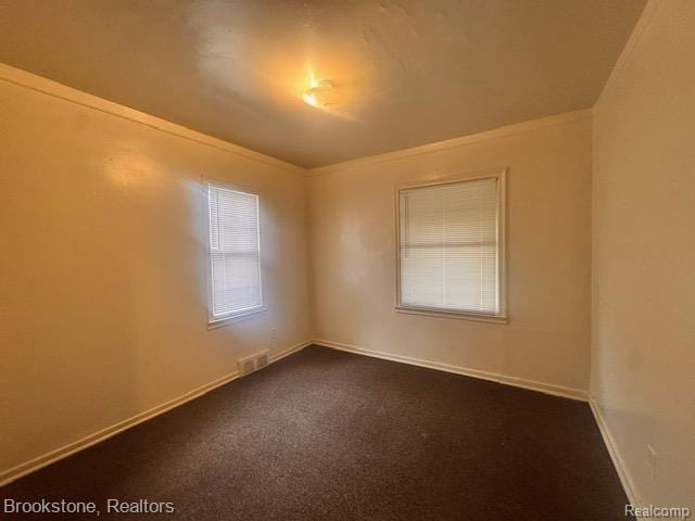 20951 Nummer St, Warren, MI 48089 - empty room featuring ornamental molding, dark carpet, and baseboards