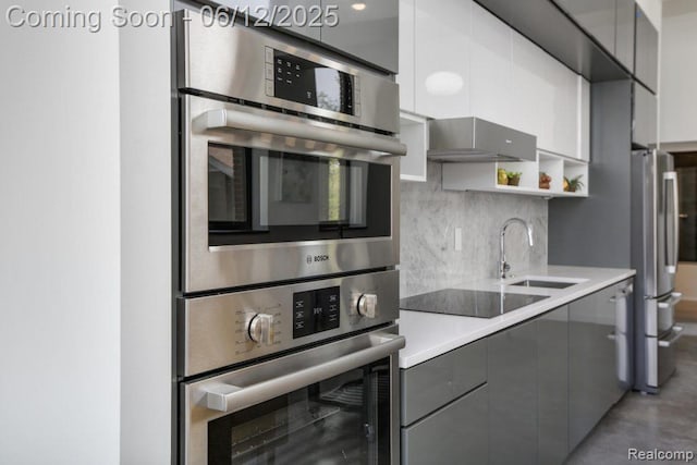 1454 Townsend St Unit 101, Detroit, MI 48214 - kitchen with a sink, gray cabinetry, freestanding refrigerator, modern cabinets, and decorative backsplash