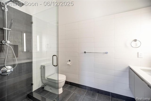1454 Townsend St Unit 101, Detroit, MI 48214 - bathroom featuring tile patterned flooring, tile walls, a shower stall, toilet, and vanity