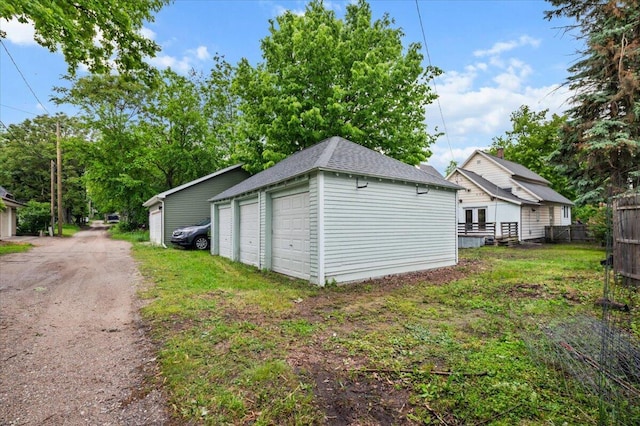 950 Crescent St NE, Grand Rapids, MI 49503 - view of home's exterior with a detached garage, an outdoor structure, and roof with shingles