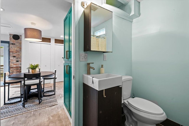 950 Crescent St NE, Grand Rapids, MI 49503 - bathroom with vanity, toilet, and wood finished floors