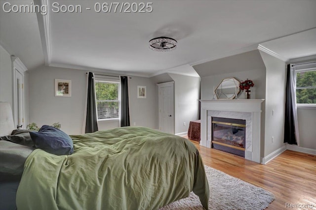 16146 Valcrest Dr, Linden, MI 48451 - bedroom featuring wood finished floors, baseboards, crown molding, and a high end fireplace