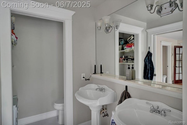 16146 Valcrest Dr, Linden, MI 48451 - bathroom featuring toilet, a sink, and baseboards
