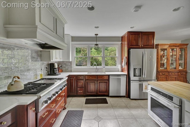 16146 Valcrest Dr, Linden, MI 48451 - kitchen featuring stainless steel appliances, a sink, light countertops, tasteful backsplash, and light tile patterned floors