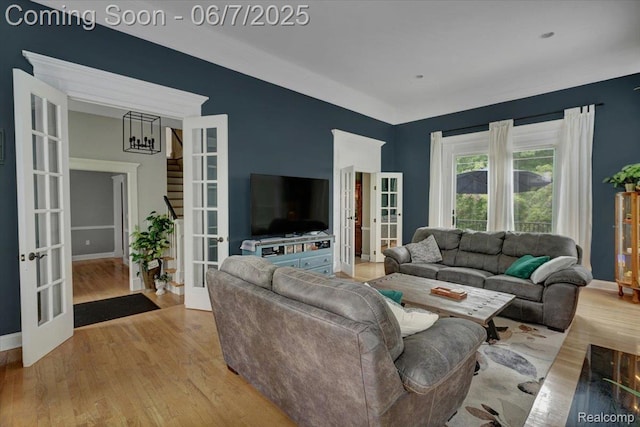 16146 Valcrest Dr, Linden, MI 48451 - living room with french doors, wood finished floors, and stairway