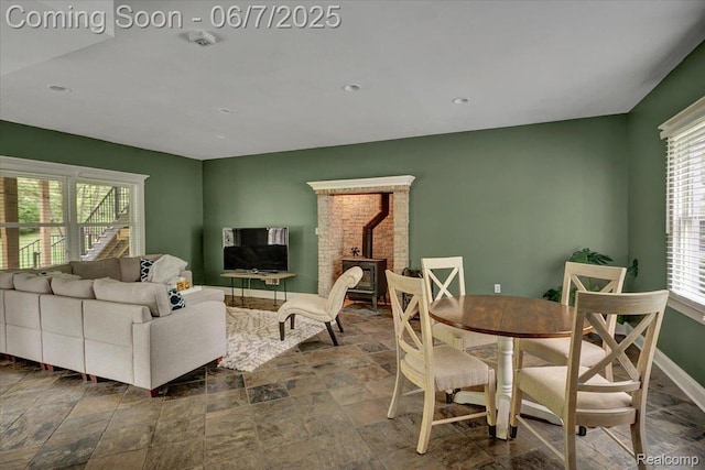 16146 Valcrest Dr, Linden, MI 48451 - living room with stone finish floors, a wood stove, baseboards, and recessed lighting
