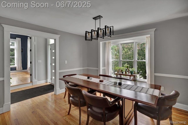 16146 Valcrest Dr, Linden, MI 48451 - dining area with a chandelier, light wood-style floors, and baseboards