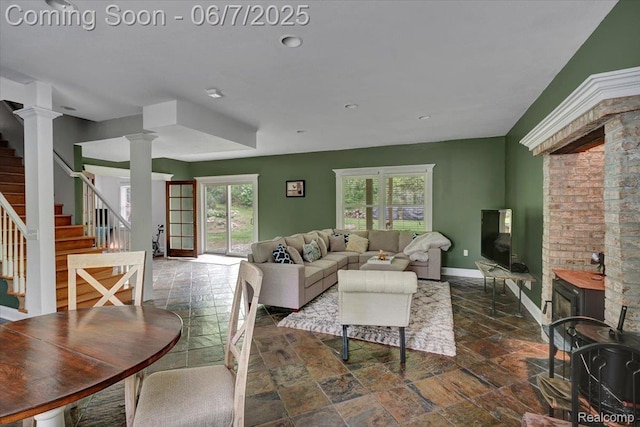 16146 Valcrest Dr, Linden, MI 48451 - living room with decorative columns, stone tile floors, stairs, and baseboards