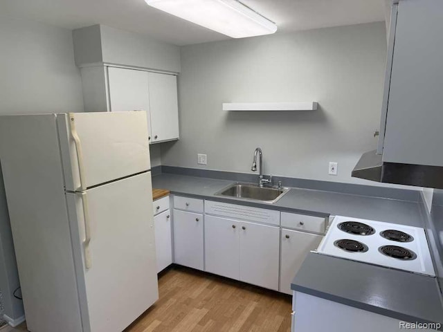 4030 W 13 Mile Rd, Lathrup Village, MI 48073 - kitchen featuring freestanding refrigerator, a sink, dark countertops, and white cabinetry